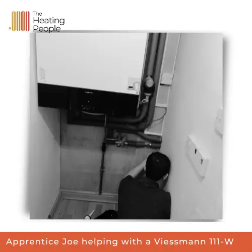 An engineer installing a Viessmann boiler